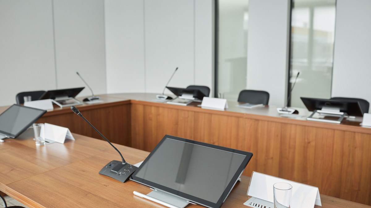 AV integration companies in India — corporate boardroom fitted with conference microphones and displays